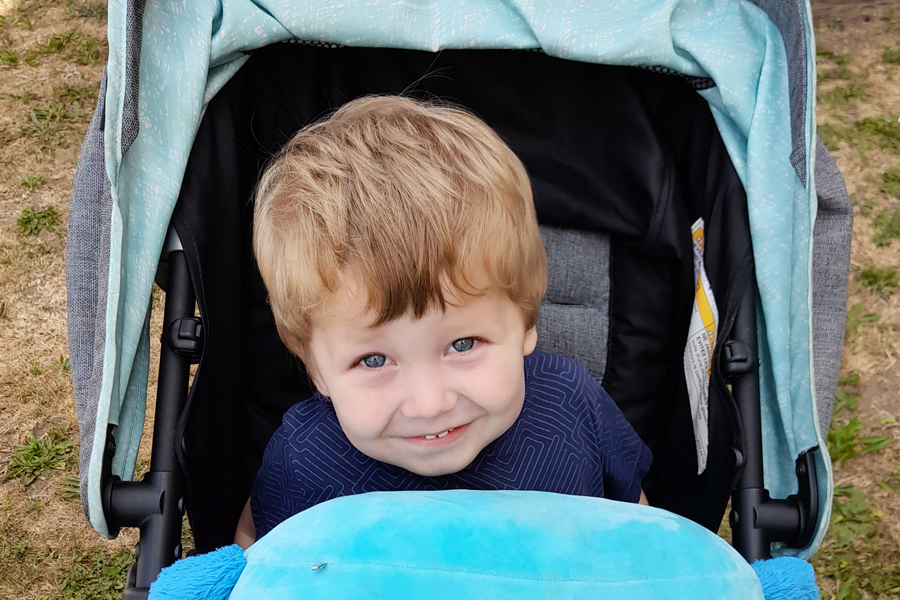 smiling young child in stroller